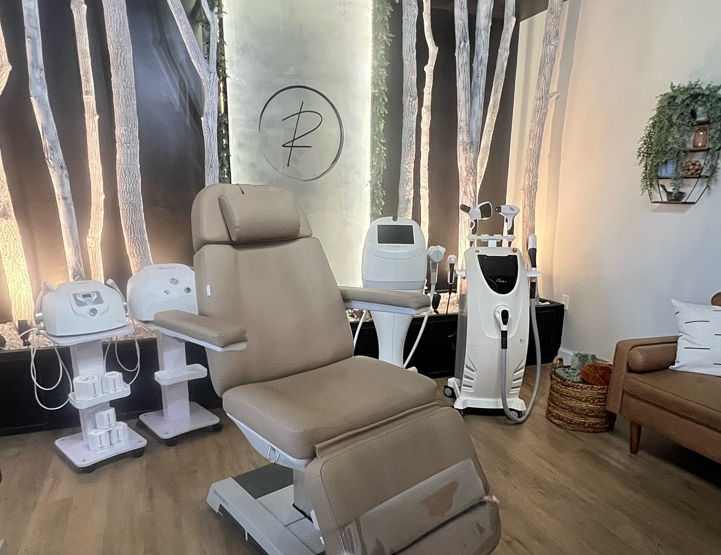 Spa treatment room with medical equipment and chair.